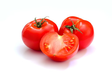 Two whole tomatoes and half on the white background