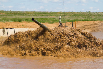 Army tank crosses the water obstacle