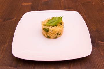 Rice with peas on a wooden table
