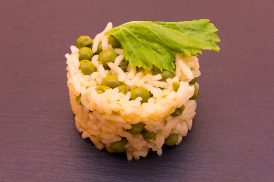 Rice with peas on a slate floor