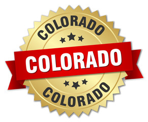 Colorado round golden badge with red ribbon