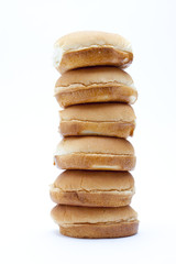 pile of burger buns arranged against white background.