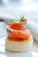 canapes with salmon and greens on a plate