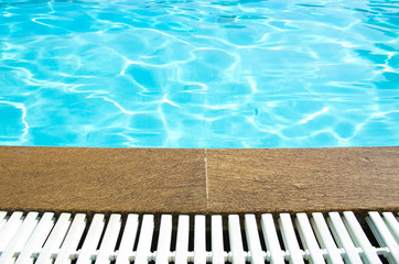 Blue pool water with sun reflections