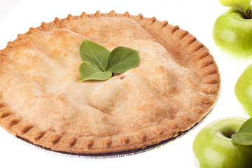 tempting apple pie with apples on side.