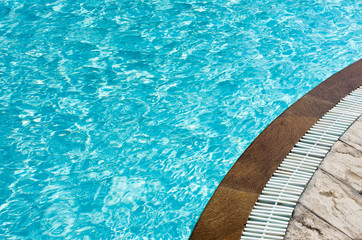 Blue pool water with sun reflections