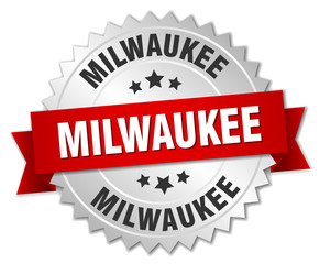 Milwaukee  round silver badge with red ribbon