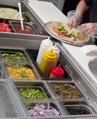 cropped image of a chef preparing burrito.