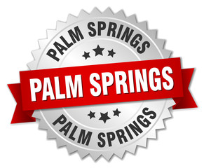 Palm Springs round silver badge with red ribbon
