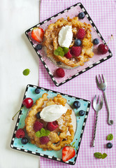 Funnel cakes with fresh berries and whipped cream