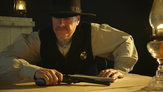 A cowboy from the American wild west era lowers his newspaper to reveal a sheriff badge then gets up and leaves with an annoyed expression.
