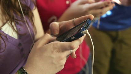 Typing a text message on her smart phone is the preferred mode of communication amongst teenagers.