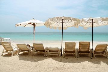 deckchairs, white sand and sea