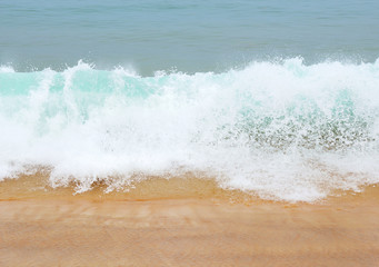Strong waves crash over the beach