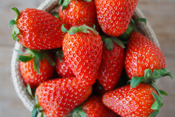 strawberries in small sack on wooden table background
