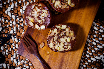 Homemade delicious fresh chocolate and almonds cake on wooden ta