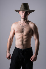 Handsome man posing with a cowboy hat.