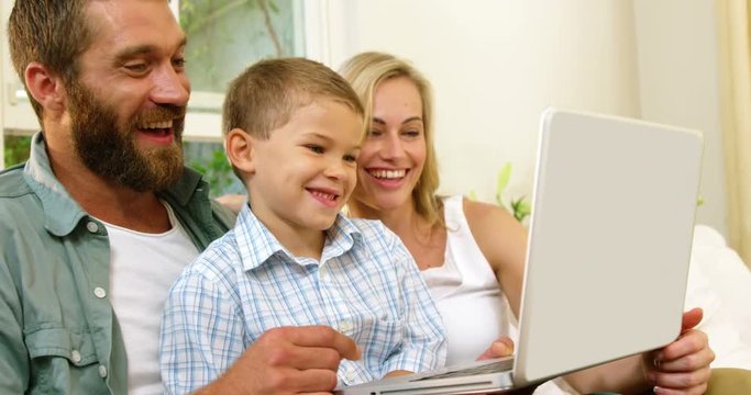 Parent and his son looking at tablet computer 