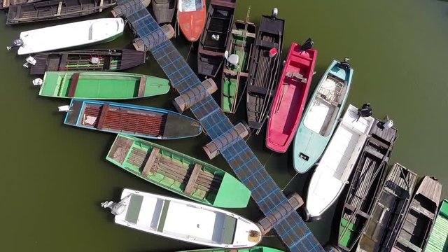 Aerial shot of beautiful river marina full of colorful boats.