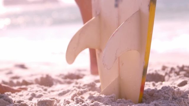 A man is taking his surfboard