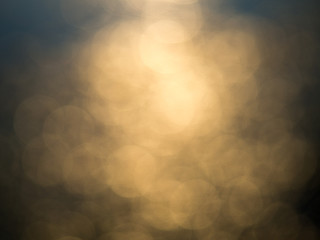 Abstract photo of backlight reflector and glitter bokeh lights background. Image is blurred and...