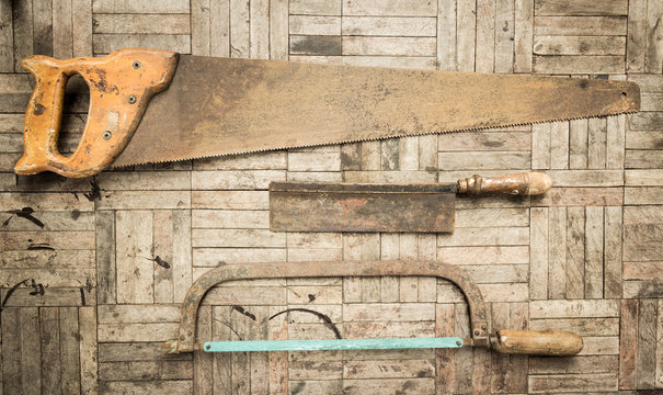set of hand saw on wooden background