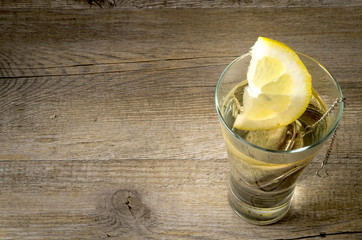 Herb's tisane with vintage silverware on rustic wooden table