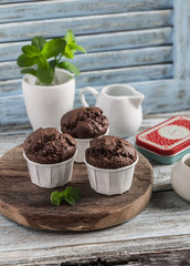 Chocolate muffins on a blue wooden background. Still life in rustic style