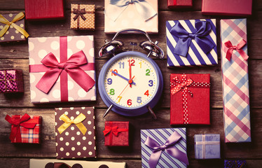 colorful gifts and clock on the table