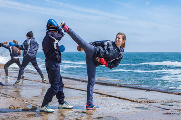 Children training karate on the stone coast