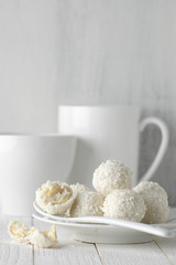 Coconut candies pile in white plate and cups