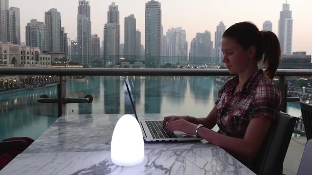 Woman working at a laptop in Dubai