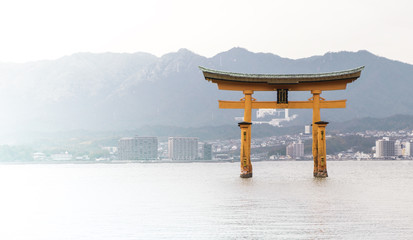 Miyajima Torii is floating on high tide sea.