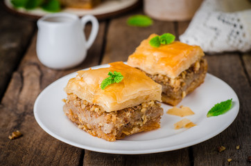 Walnuts baklava on wooden background. East sweets. Ramadan food. Selective focus