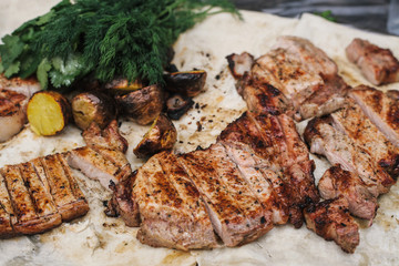 Grilled steak, bacon and potatoes with herbs lies in the pita. The concept of eating outdoors in the weekend.
