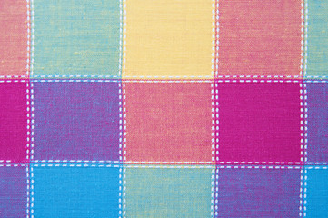 The texture of the textile colored squares of cotton, stitched 