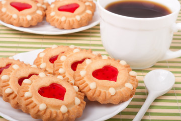 Obraz na płótnie Canvas cookie with heart jelly and cup of coffee bamboo napkin
