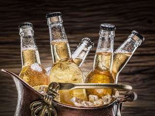Cold bottles of beer in the brazen bucket.