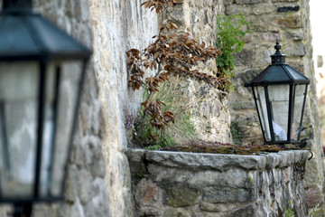 Historical street lamp on the stone wall