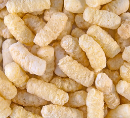 Background from corn sticks with sugar powder. Closeup image.