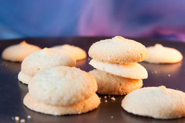 Cookies on the dark brown plate on the colorful background
