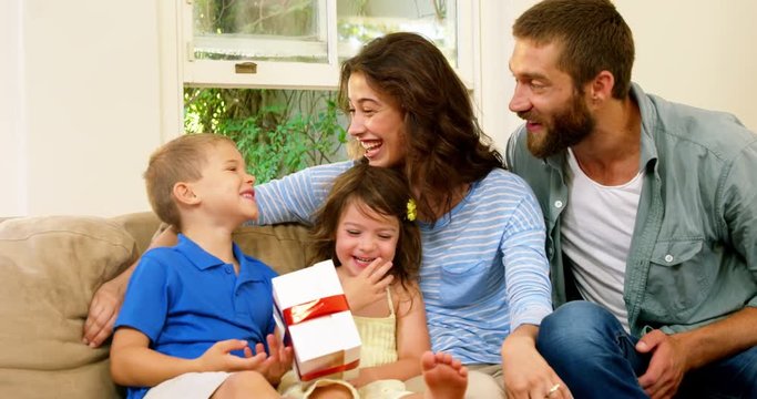 Family offering a gift to the son