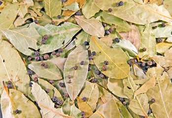 Background from bay leaves and peppercorns