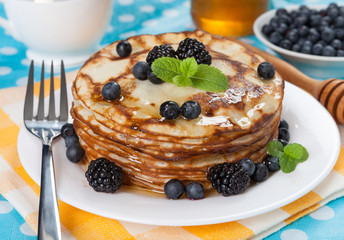 Delicious pancakes with blackberries and mint leaves