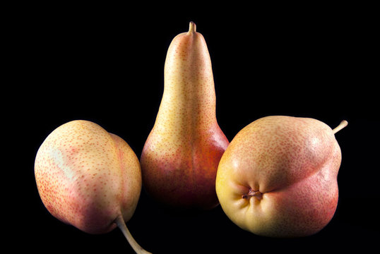Three pears on the black background