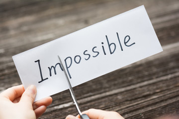 holds card with text on old wood plate