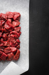Closeup Raw sliced beef meat on dark background. Background with copy space. Selective focus. Top view