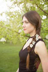 Fototapeta premium Close up view of young woman's tress with flowers