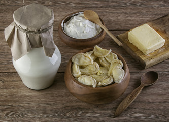 Ukraine dumplings with dairy products on the wooden table