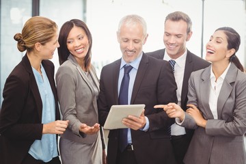 Businesspeople interacting and using digital tablet